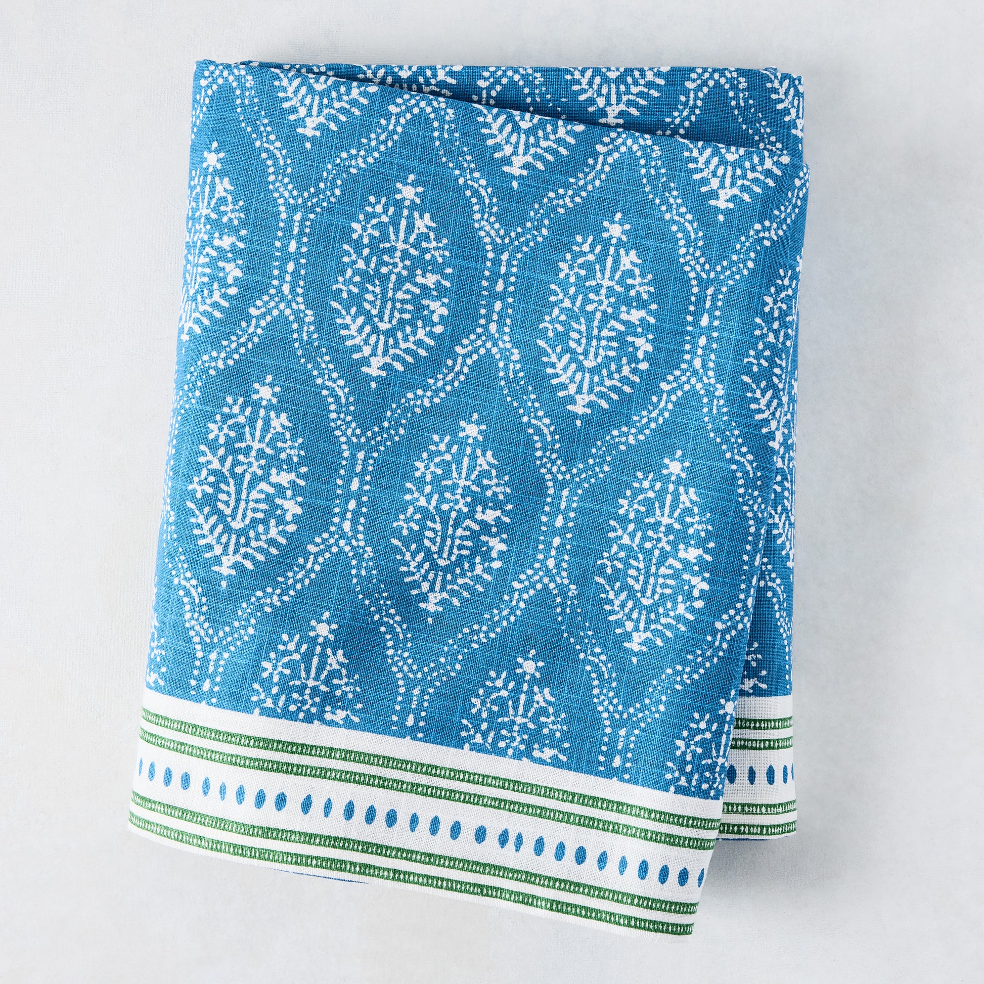 Peter Dunham + Hudson Grace Blue Jaali Printed Tablecloth, 100% cotton slub, with green border.