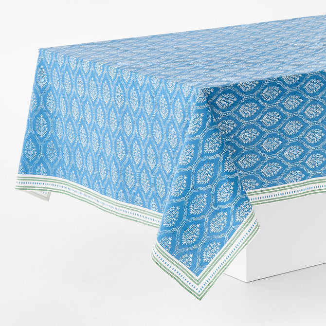 Peter Dunham blue and white cotton slub rectangular tablecloth with a floral Jaali print and green border.