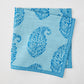 Folded Peter Dunham + Hudson Grace Blue Kashmir Paisley Printed Napkin with intricate blue block print.