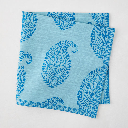 Folded Peter Dunham + Hudson Grace Blue Kashmir Paisley Printed Napkin with intricate blue block print.