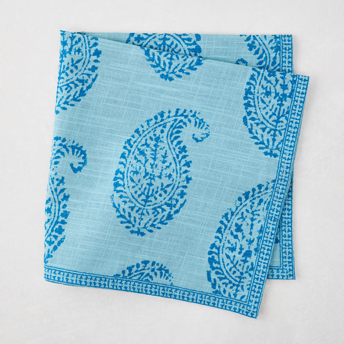 Folded Peter Dunham + Hudson Grace Blue Kashmir Paisley Printed Napkin with intricate blue block print.