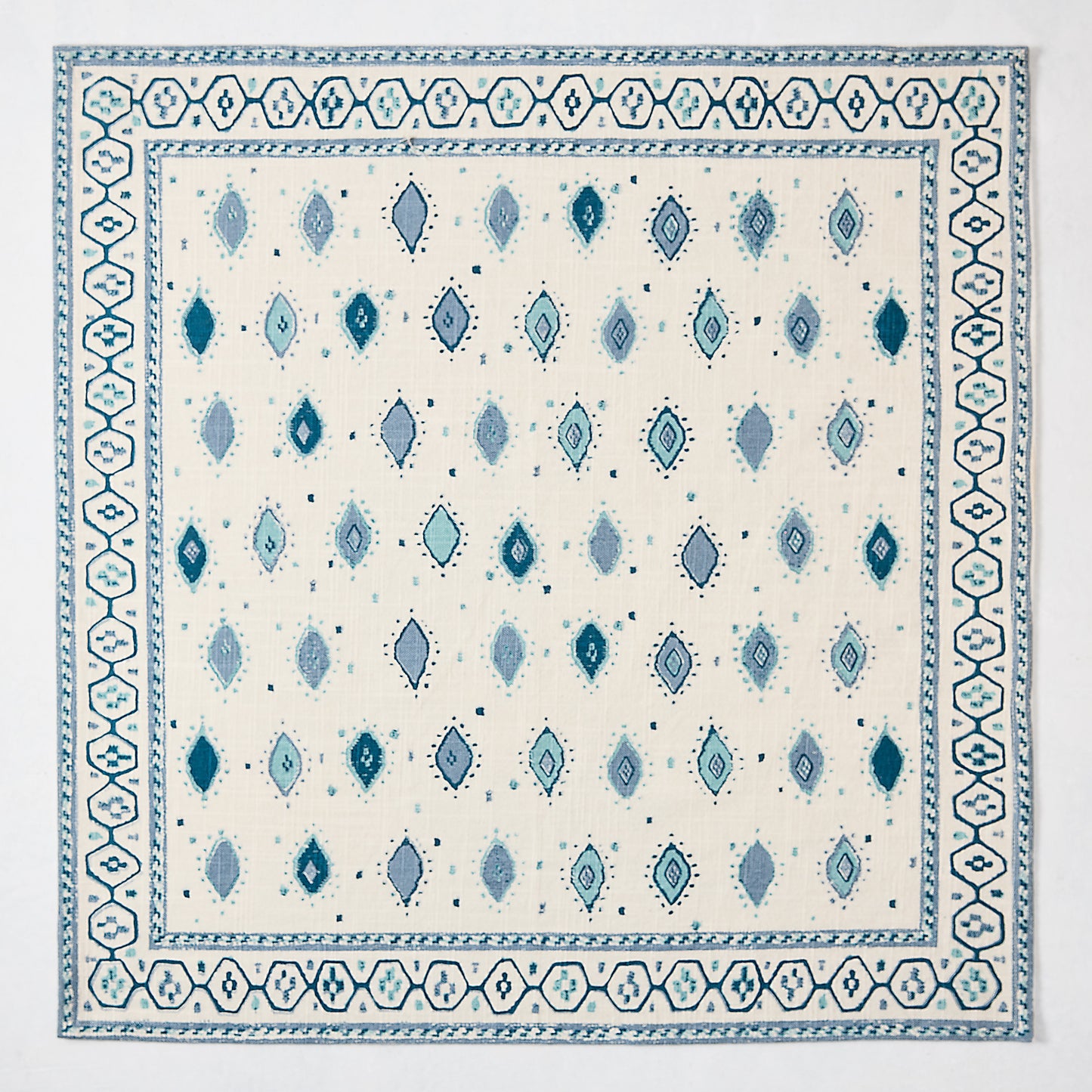 Peter Dunham + Hudson Grace Blue Oona Printed Napkin, ivory cotton slub with tribal blue diamond pattern and border.