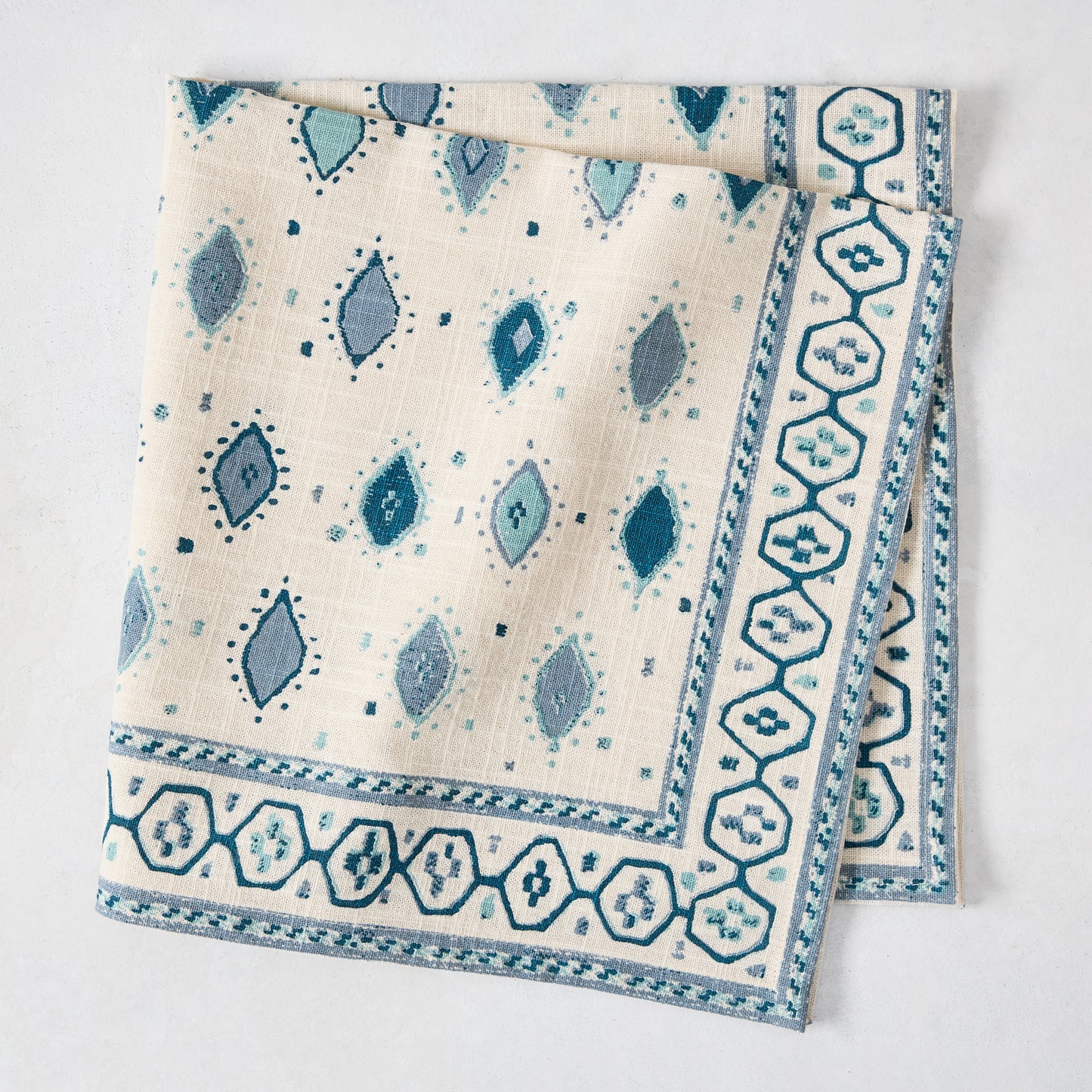 Peter Dunham + Hudson Grace Blue Oona printed cotton slub napkin with tribal motif and bold border.
