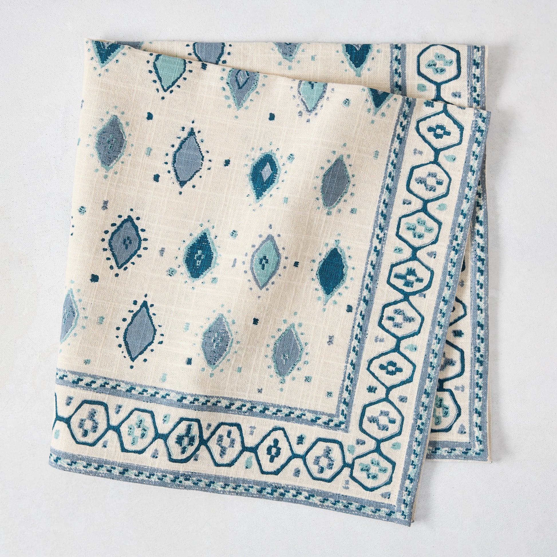 Peter Dunham + Hudson Grace Blue Oona printed cotton slub napkin with tribal motif and bold border.