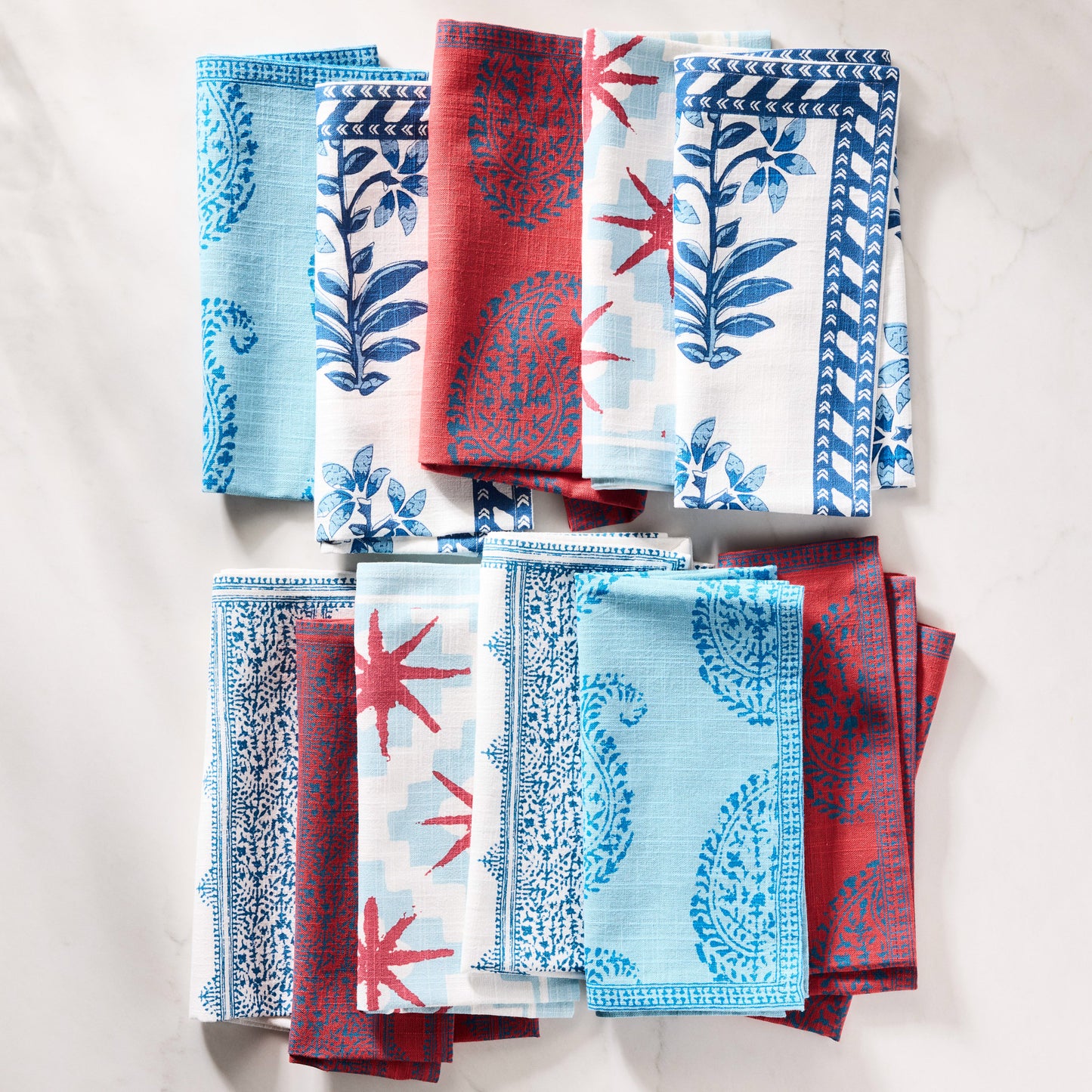 Peter Dunham + Hudson Grace Blue Starburst cotton napkins with blue geometric and red starburst patterns.