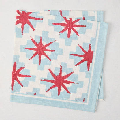 Peter Dunham + Hudson Grace Blue Starburst Printed Napkin, 100% cotton slub, red starbursts on blue geometric.