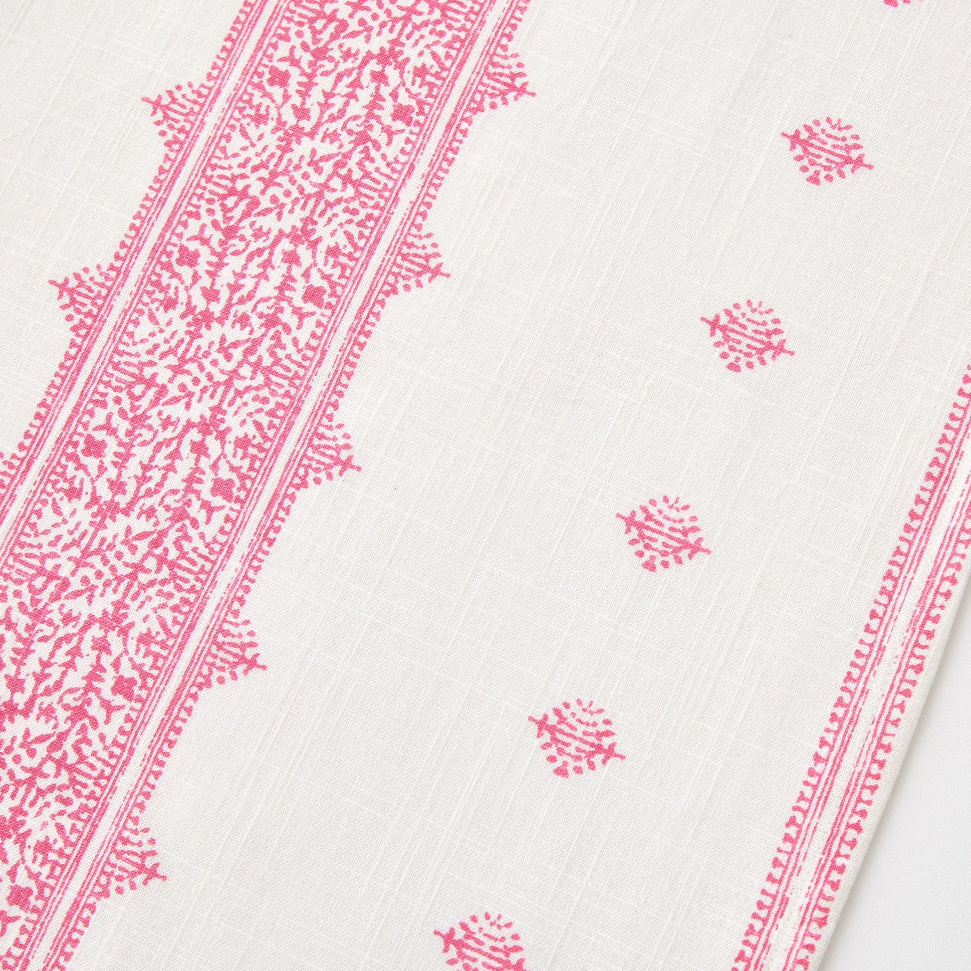 Bright pink Fez print on white 100% cotton slub table runner with intricate embroidery-inspired patterns.