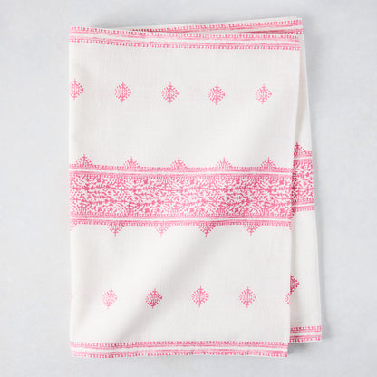 Bright pink Fez printed cotton slub table runner, folded, with intricate patterns on white.