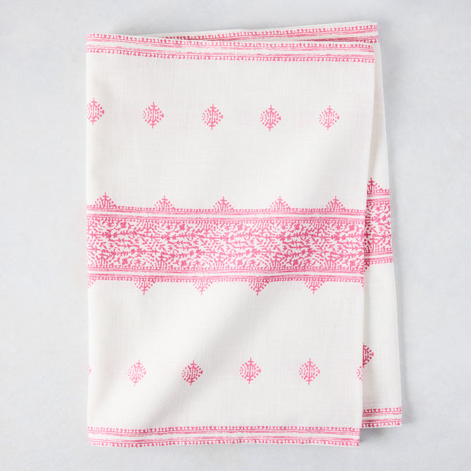 Bright pink Fez printed cotton slub table runner, folded, with intricate patterns on white.