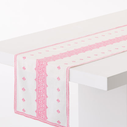 Peter Dunham + Hudson Grace bright pink Fez print cotton slub table runner on a white table.