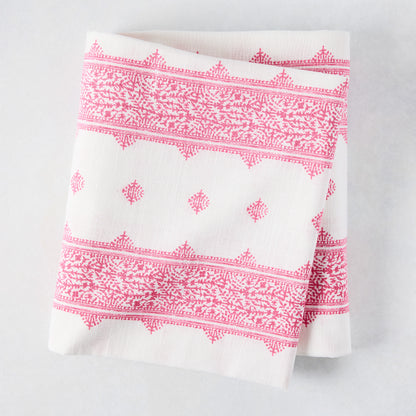 Folded Peter Dunham + Hudson Grace Bright Pink Fez Stripe cotton slub tablecloth with intricate pattern.