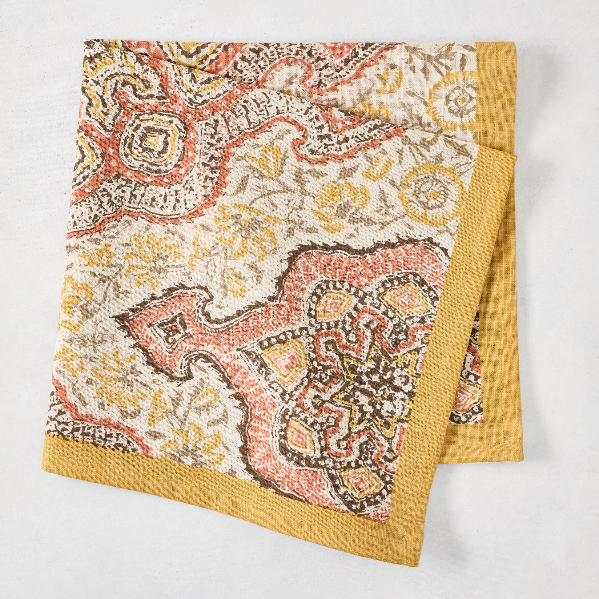 Gold and Spice Orange Deeg Printed Napkin, 100% cotton slub, with yellow border.