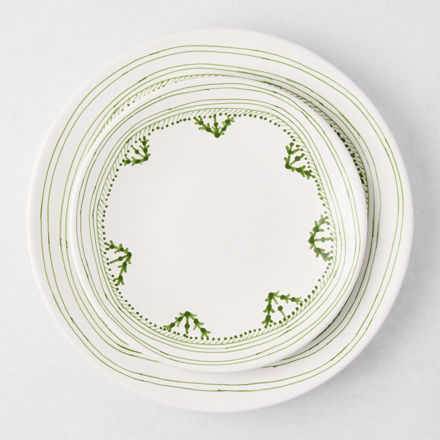 Peter Dunham + Hudson Grace Green Fez hand-painted border dinner plate, white with green abstract pattern.