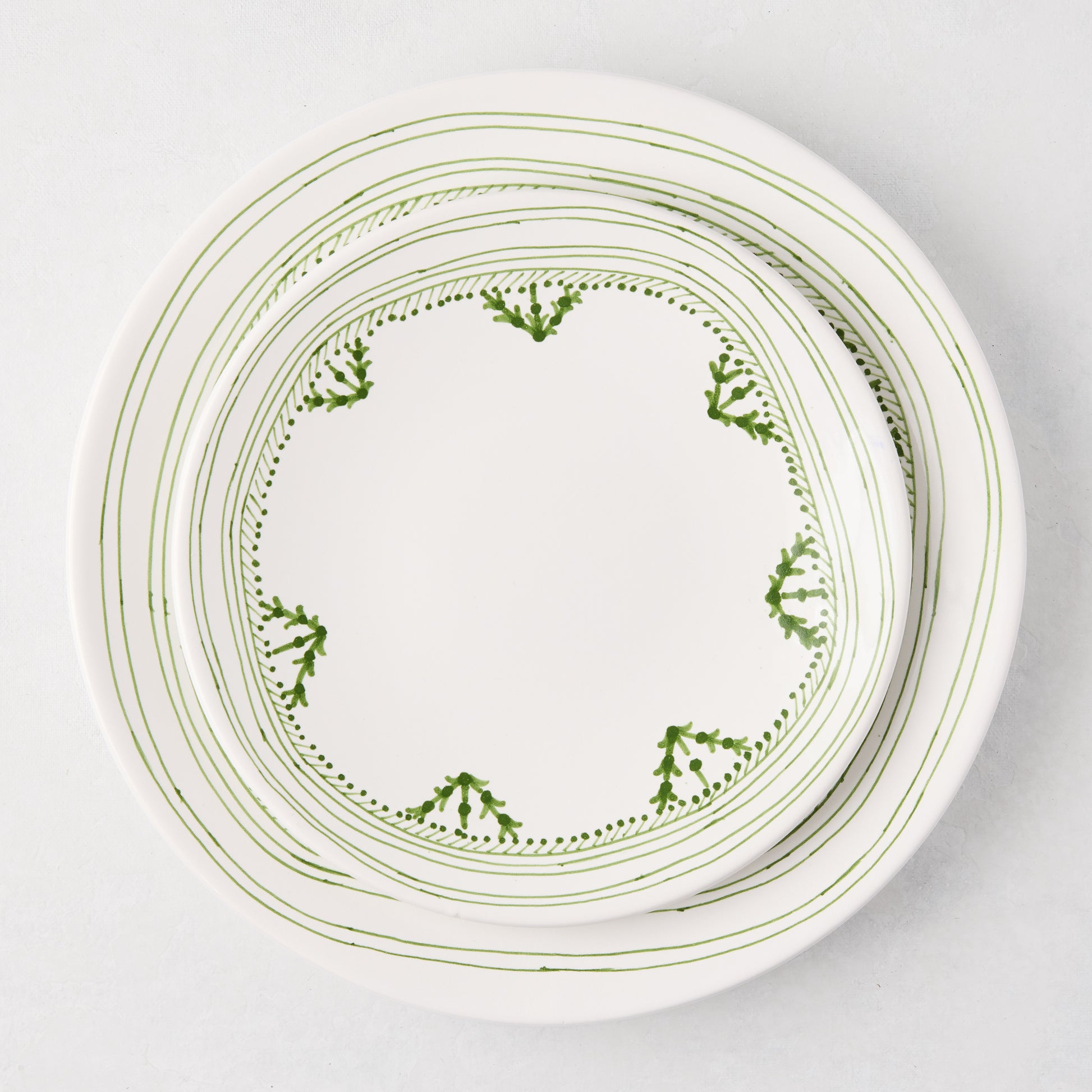 Peter Dunham + Hudson Grace Green Fez hand-painted border dinner plate, white with green abstract pattern.