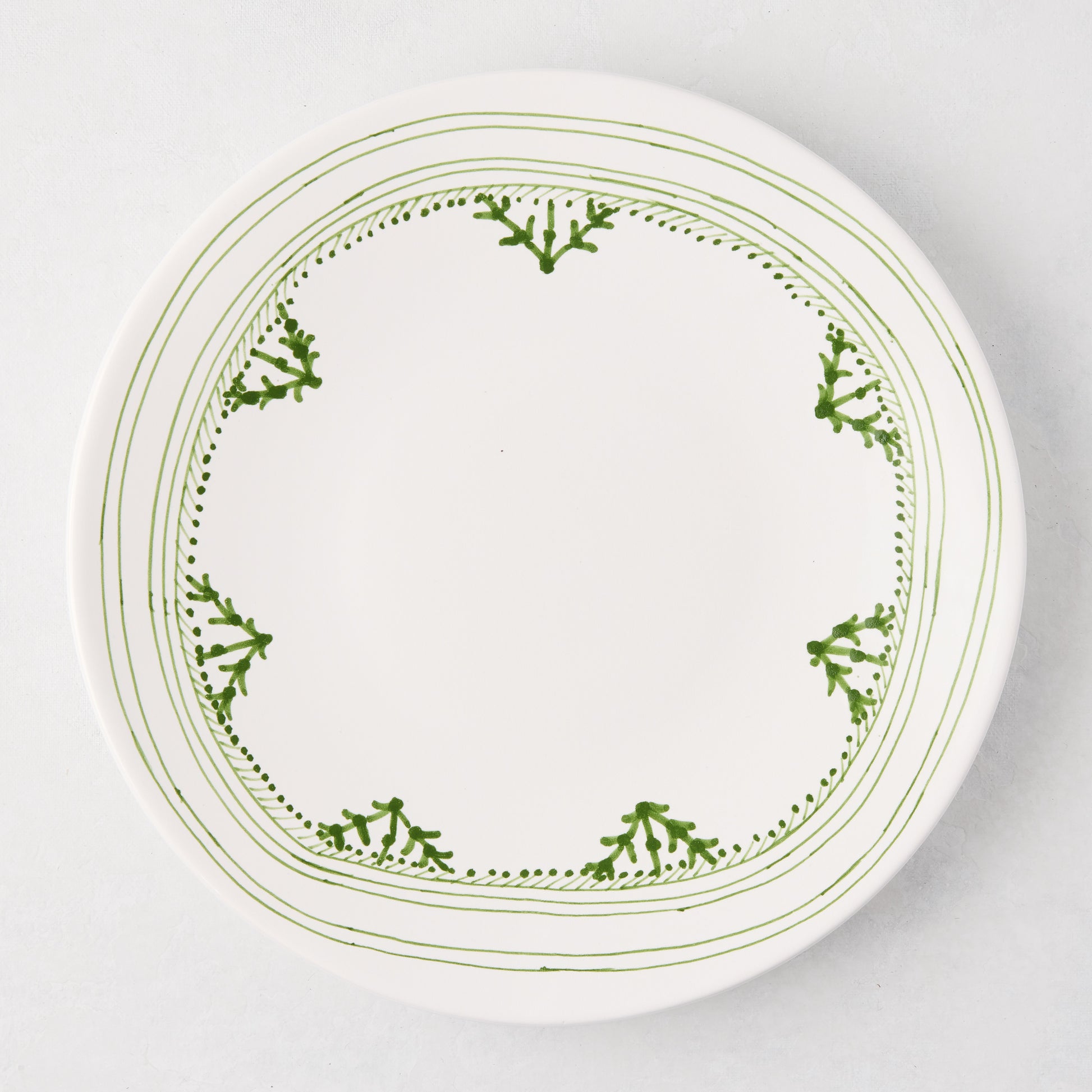 Peter Dunham + Hudson Grace Green Fez hand-painted border dinner plate, white with green pattern.