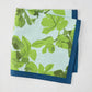 Peter Dunham + Hudson Grace Green Fig Leaf Printed Blue Napkin with blue border, 100% cotton slub.