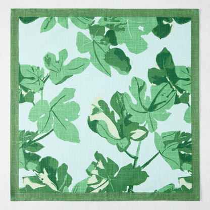 Peter Dunham + Hudson Grace Green Fig Leaf printed pale blue cotton slub napkin with green border.