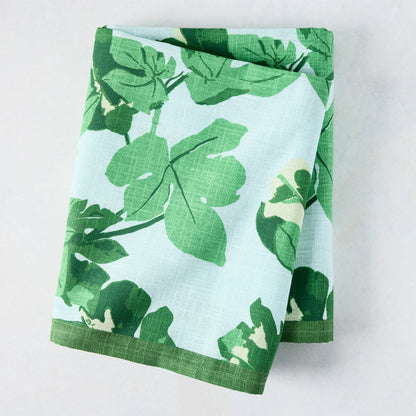 Peter Dunham + Hudson Grace Green Fig Leaf Printed Pale Blue Tablecloth, 100% cotton slub, folded.