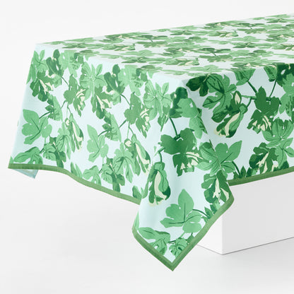 Peter Dunham cotton slub tablecloth with green fig leaf print on pale blue background, 108x70 inches.