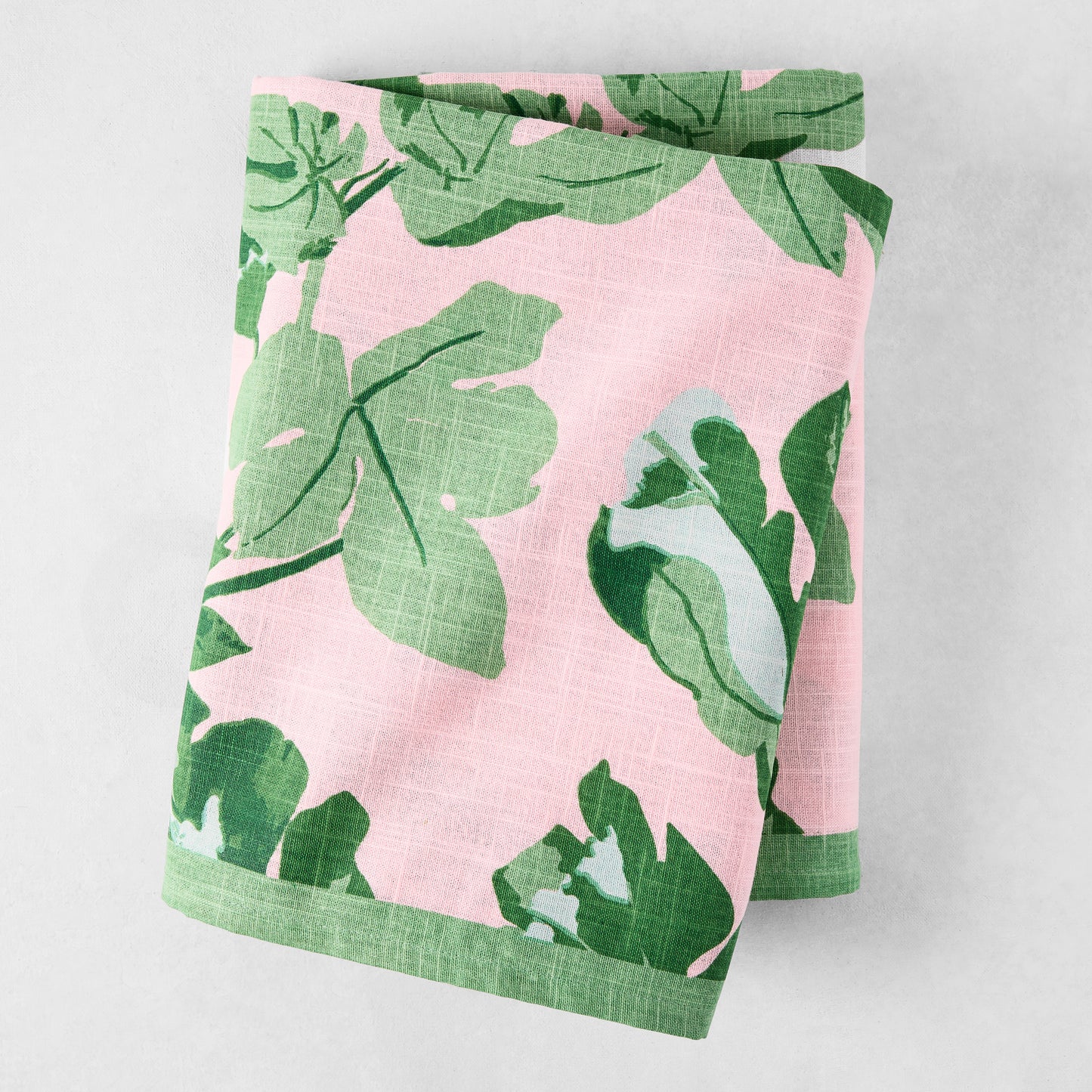 Peter Dunham + Hudson Grace Green Fig Leaf Printed Pink Tablecloth, 100% cotton slub, folded.