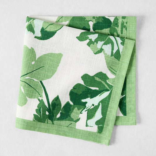 Peter Dunham + Hudson Grace Green Fig Leaf printed white cotton napkin with green border.