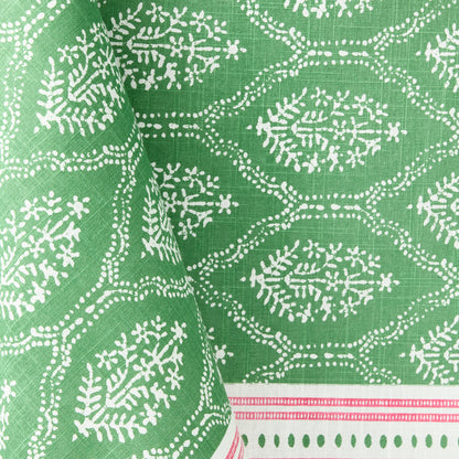 Green cotton slub tablecloth with white Jaali floral block print and a decorative pink border.