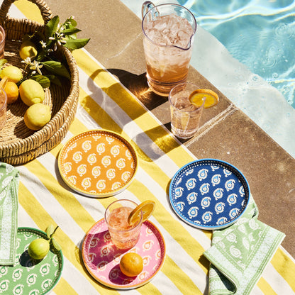 Peter Dunham + Hudson Grace melamine salad plates with colorful paisley patterns on a yellow striped outdoor towel.