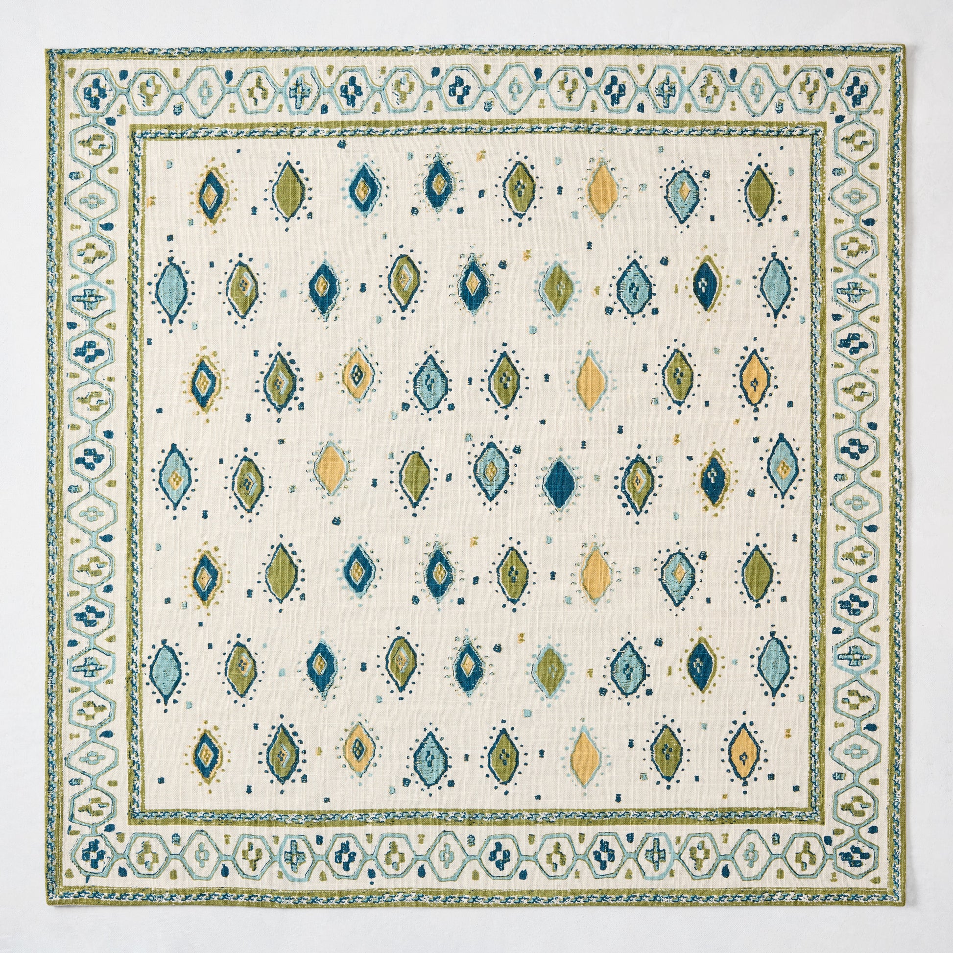 Peter Dunham + Hudson Grace Green Oona Printed Napkin: ivory cotton slub with tribal green and blue pattern.
