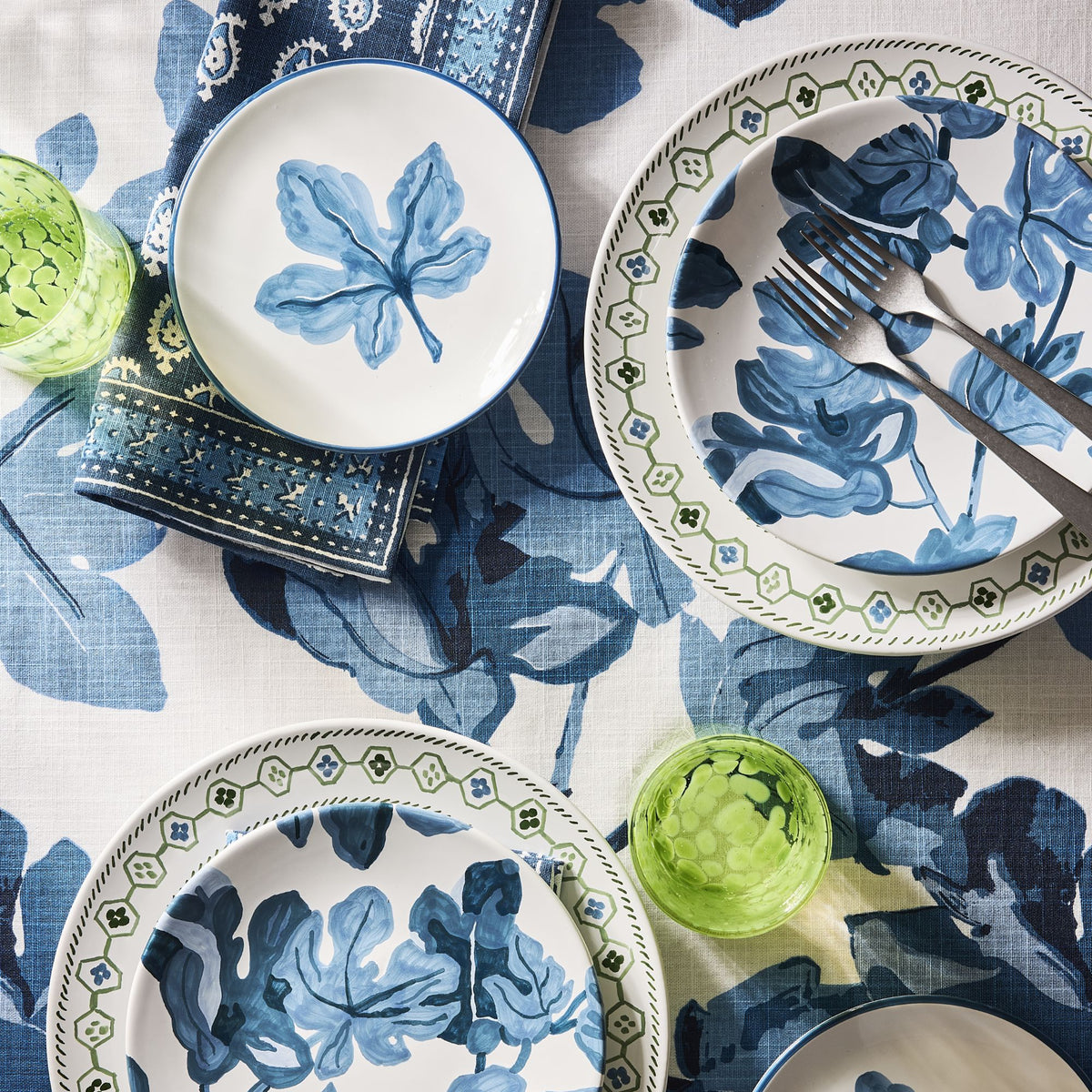 Hand-painted ceramic appetizer plate with blue fig leaf motif and blue border from Peter Dunham + Hudson Grace collection.