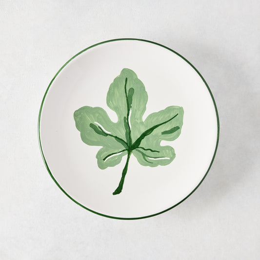 Peter Dunham + Hudson Grace hand-painted white appetizer plate with a green fig leaf and green border.