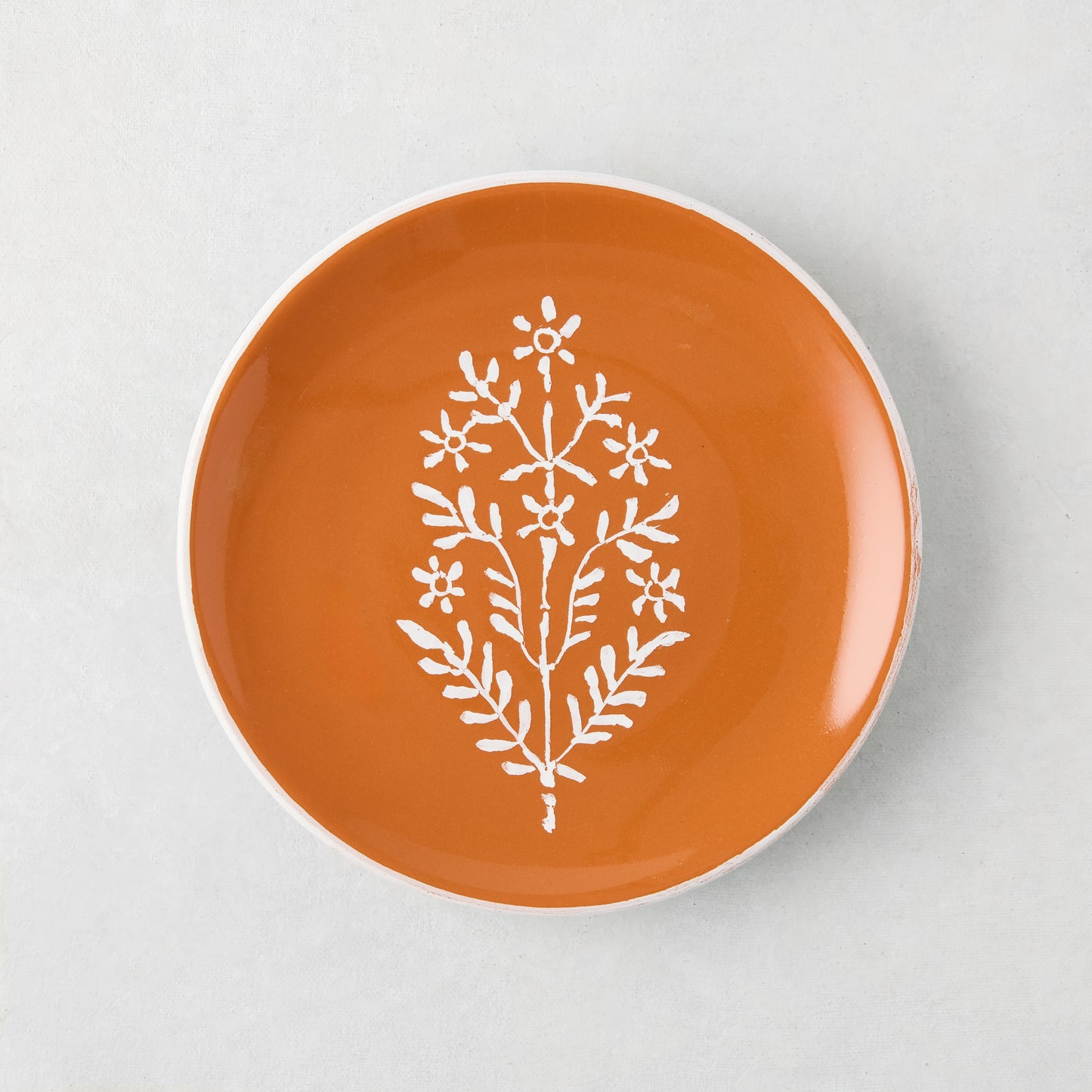 Peter Dunham + Hudson Grace Jaali Spice Orange Appetizer Plate with white hand-painted floral pattern.