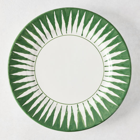 Peter Dunham + Hudson Grace hand-painted dark green sunburst dinner plate with white center.