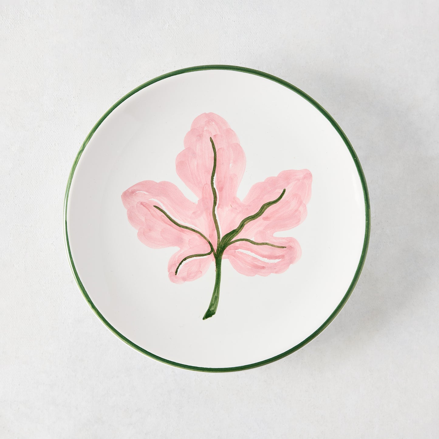 Peter Dunham + Hudson Grace hand-painted white appetizer plate with pink fig leaf and green border.