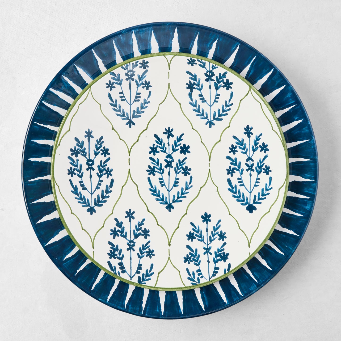 Peter Dunham + Hudson Grace Indigo Blue Hand-Painted Sunburst Dinner Plate with floral ikat pattern.