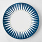 Peter Dunham + Hudson Grace Indigo Blue Hand-Painted Sunburst Dinner Plate with ikat stripe pattern.
