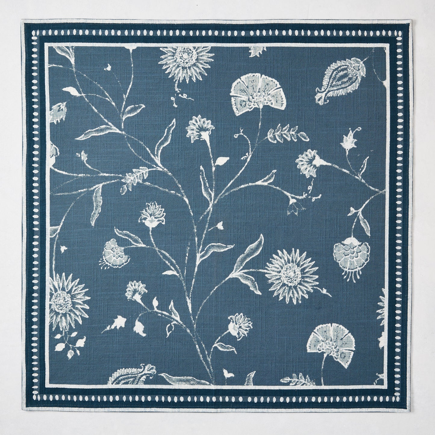 Peter Dunham + Hudson Grace Indigo Blue Indian Chintz cotton slub napkin with floral and border pattern.