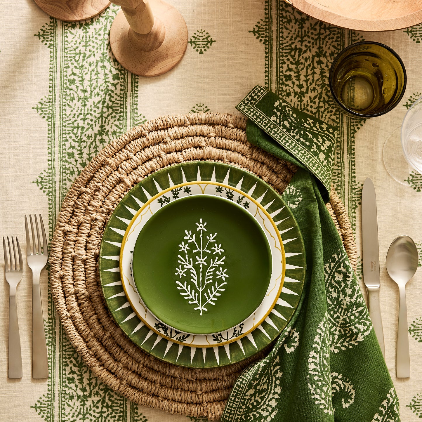 Peter Dunham + Hudson Grace Kashmir Paisley Olive Green Printed Napkin on a set table.