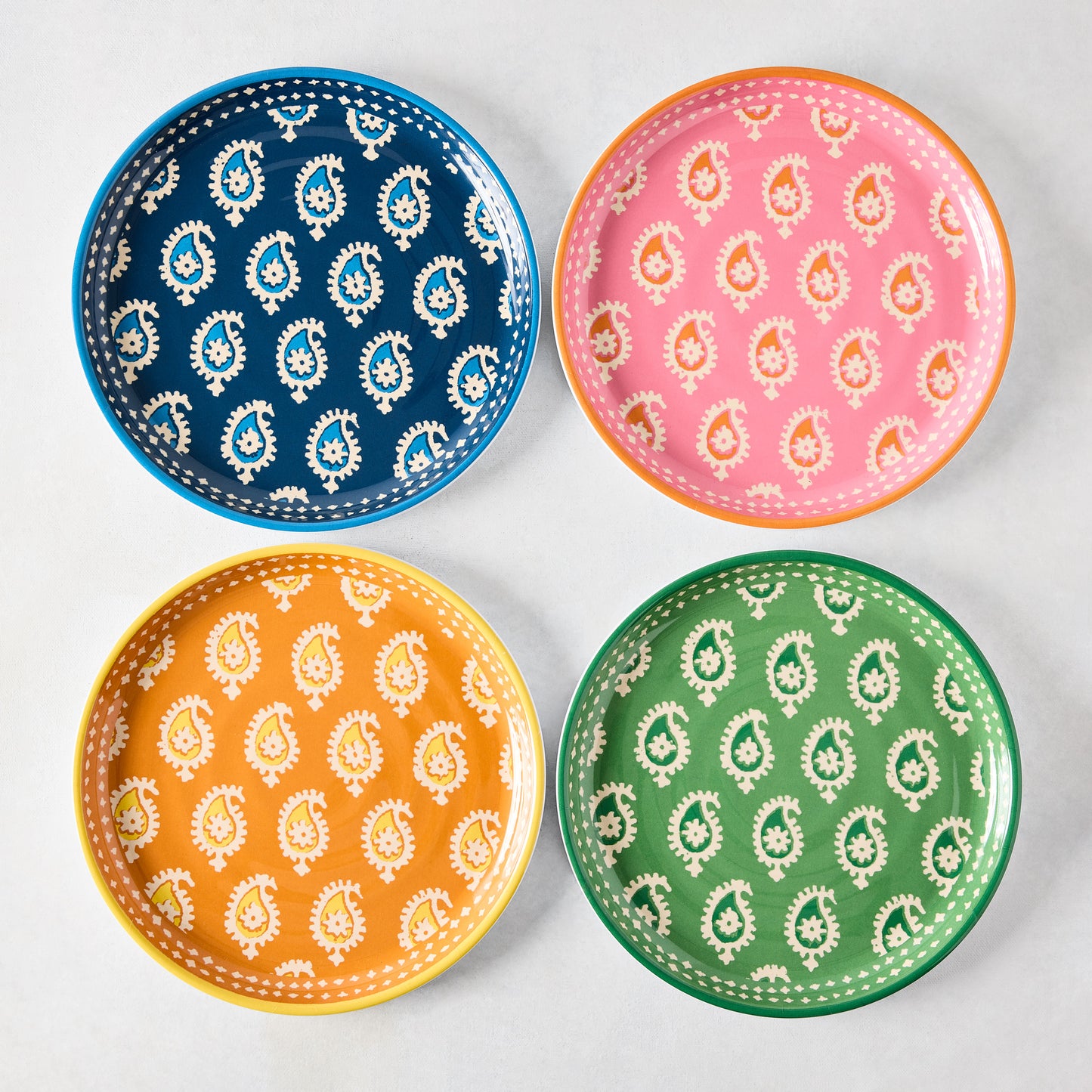 Four Peter Dunham + Hudson Grace Janpath melamine salad plates in navy, pink, orange, and green paisley.