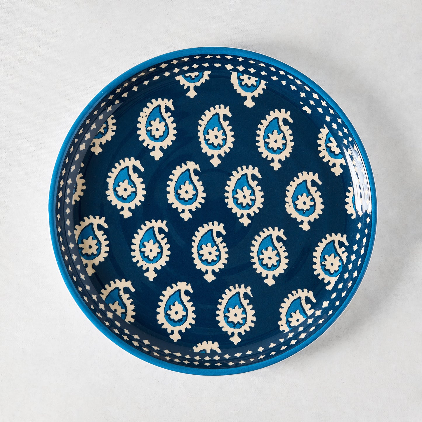 Peter Dunham + Hudson Grace Navy Blue Janpath Melamine Salad Plate with pale blue paisley pattern.