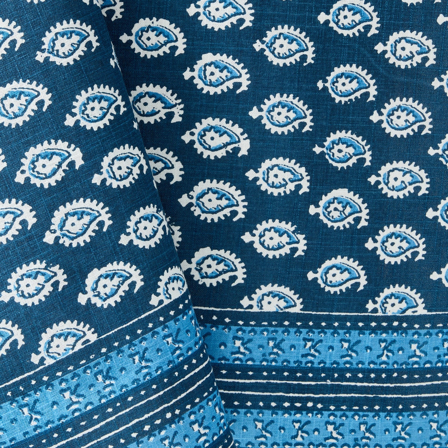 Navy blue cotton slub tablecloth with white paisley print and graphic border detail from Peter Dunham + Hudson Grace.