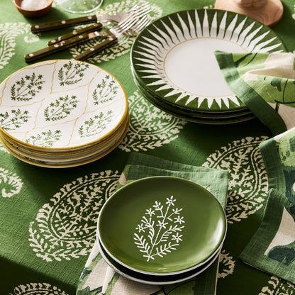 Peter Dunham + Hudson Grace Olive Green Hand-Painted Jaali Salad Plate with white floral pattern on a green tablecloth.