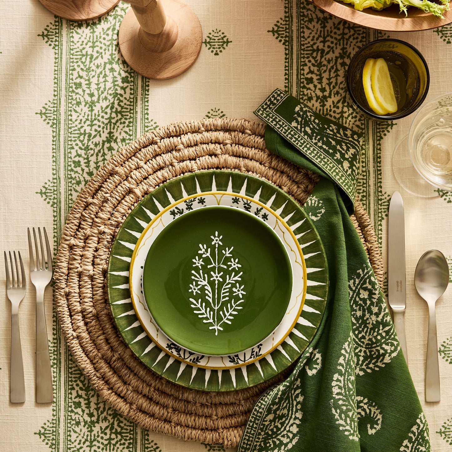 Peter Dunham + Hudson Grace Olive Green Hand-Painted Jaali Salad Plate with yellow border on a woven placemat.