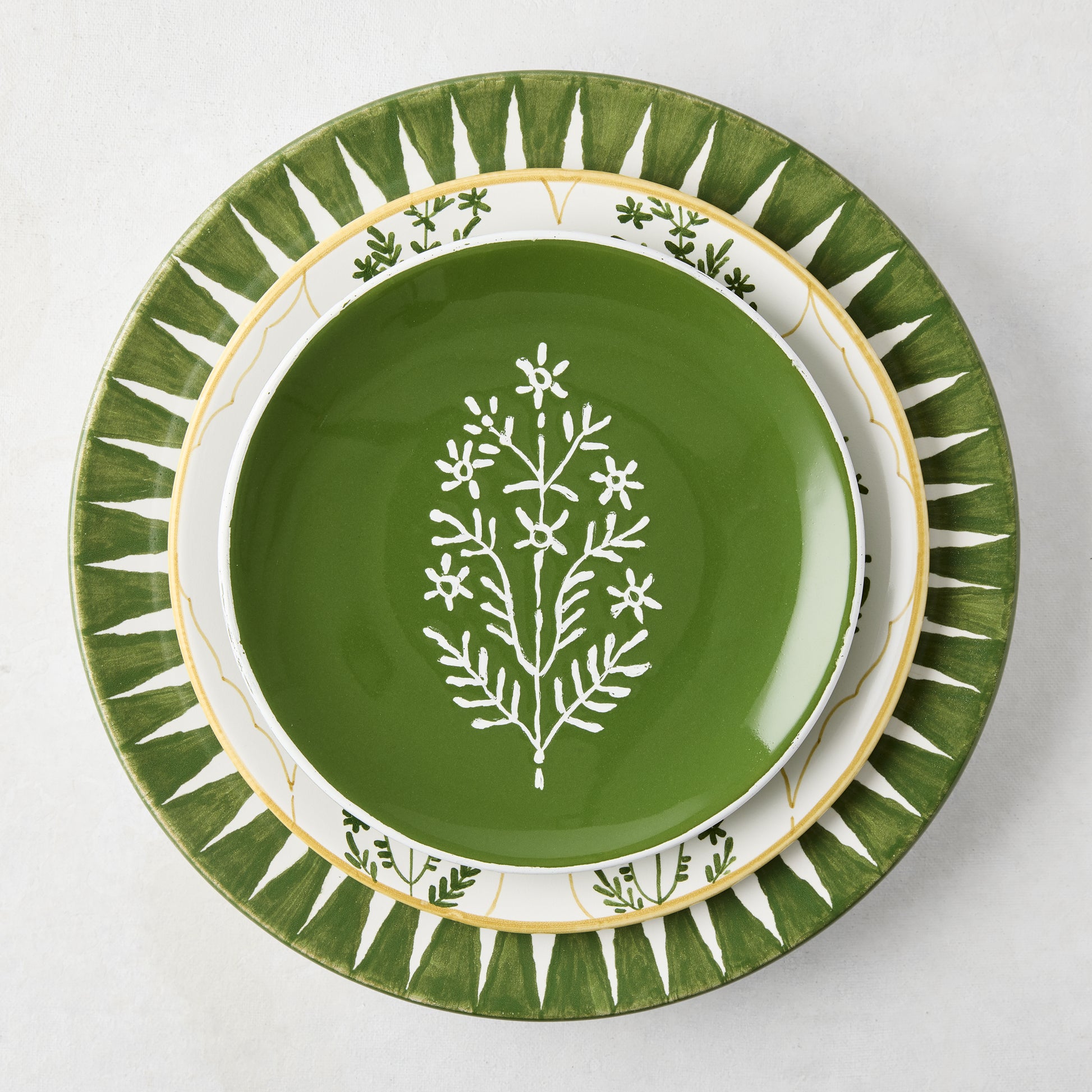 Peter Dunham + Hudson Grace olive green hand-painted sunburst dinner plate with ikat stripe.