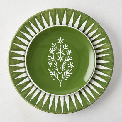Peter Dunham + Hudson Grace Olive Green Hand-Painted Sunburst Dinner Plate with a smaller green plate featuring a white floral design.
