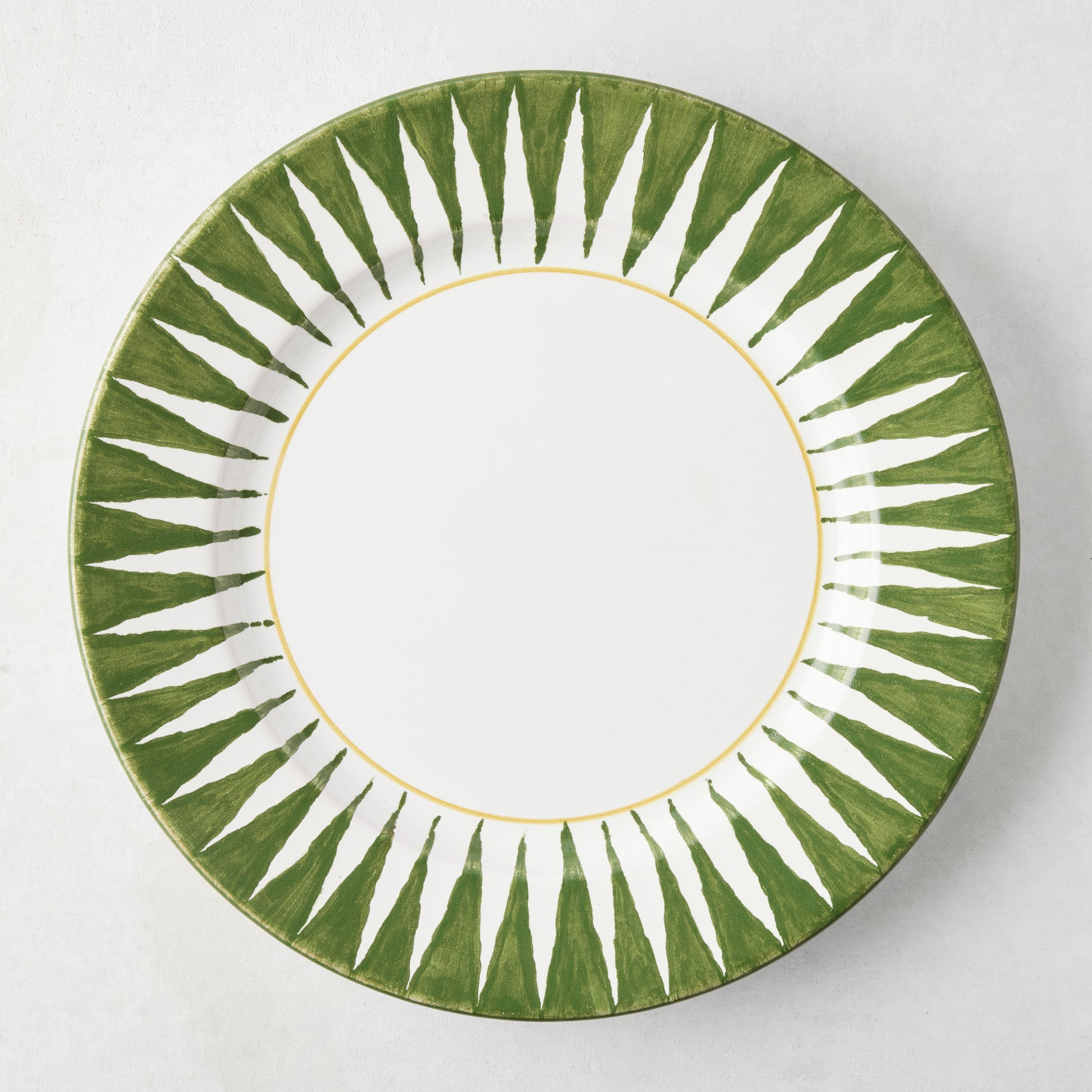 Peter Dunham + Hudson Grace olive green hand-painted sunburst dinner plate with white center and yellow rim.
