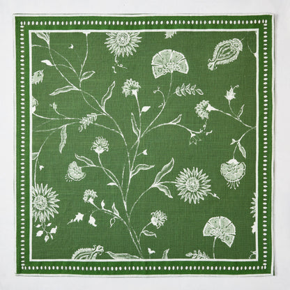 Olive green Indian Chintz printed napkin with white rambling floral pattern and antique rug-inspired border.