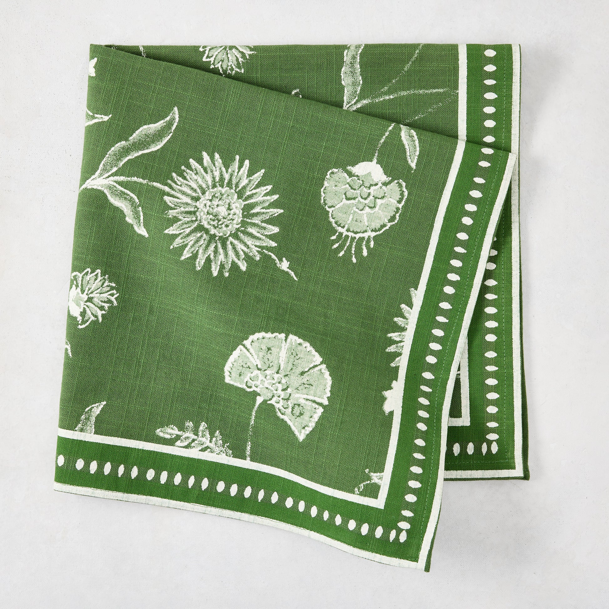 Olive green cotton slub napkin with white Indian chintz floral print and dotted border.