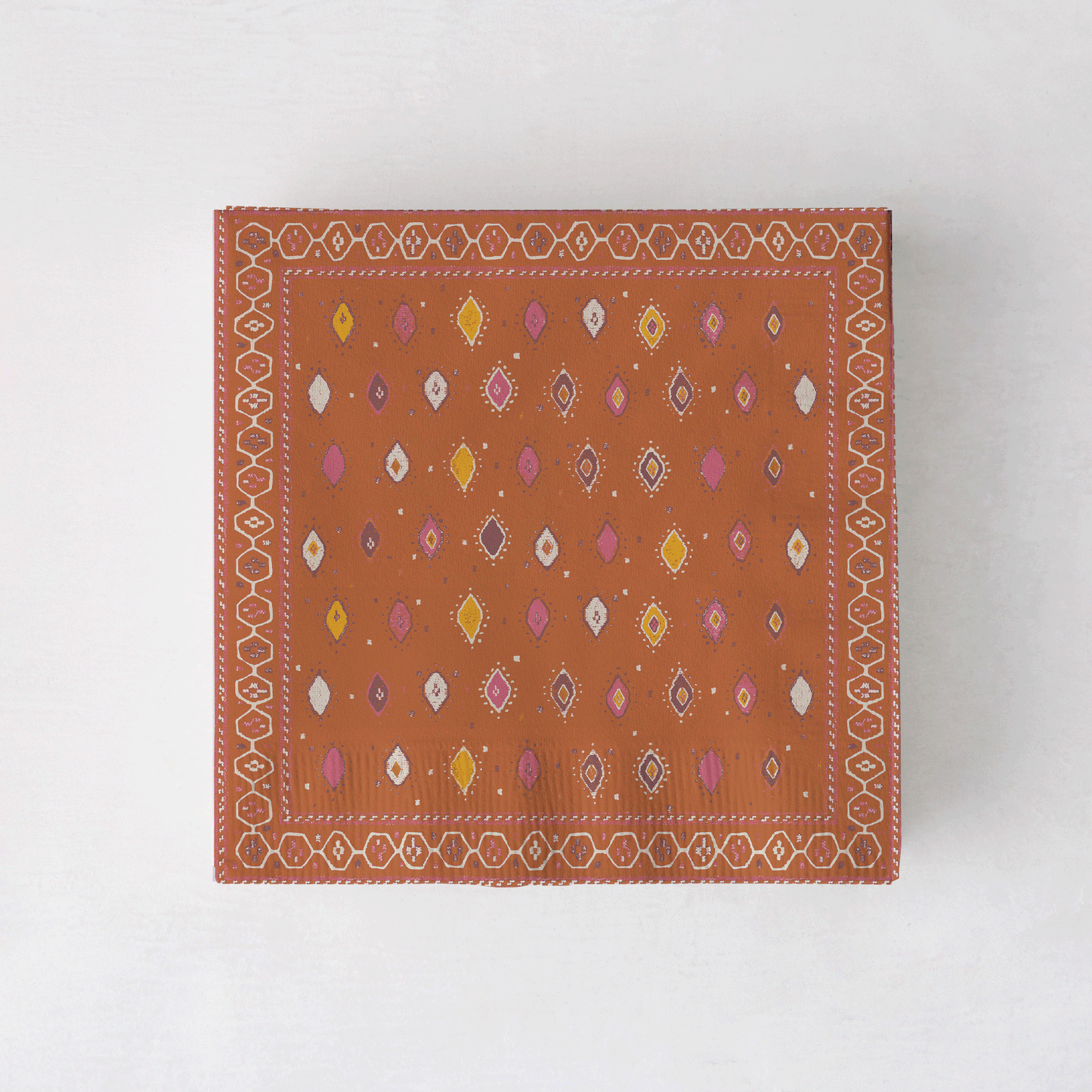 Peter Dunham + Hudson Grace Oona cocktail napkins with tribal motif in orange, pink, and yellow.