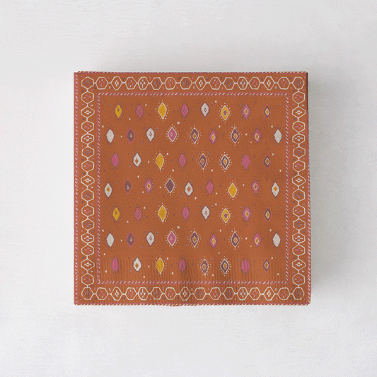 Peter Dunham + Hudson Grace Oona cocktail napkins with tribal motif in orange, pink, and yellow.