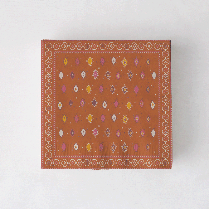 Peter Dunham + Hudson Grace Oona cocktail napkins with tribal motif in orange, pink, and yellow.